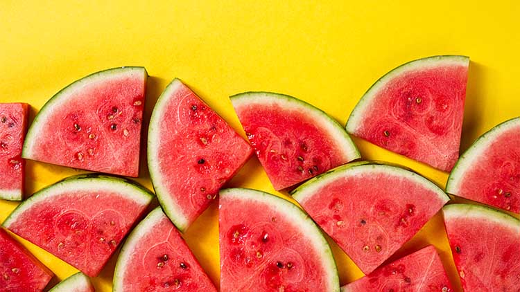 Beautiful pattern with fresh watermelon slices on yellow bright background. Top View.