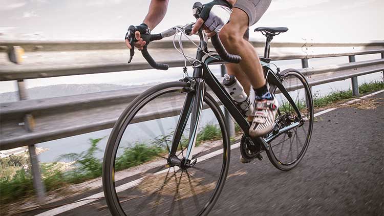 Detail of a road bike with a cyclist pedaling