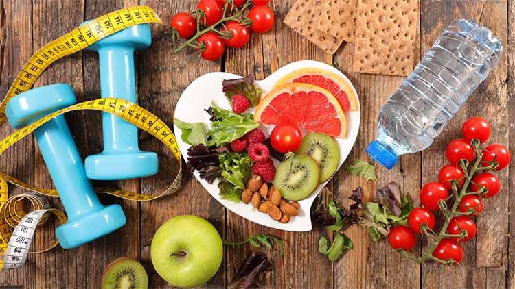 fruit and veg laid out on a wooden table, on top of a heart shaped plate