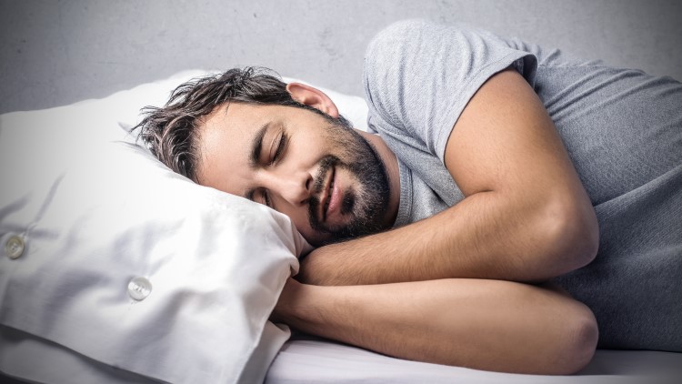 Smiling man asleep alone