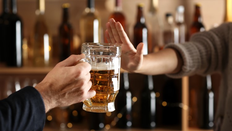 Man refusing to take alcoholic drink in bar