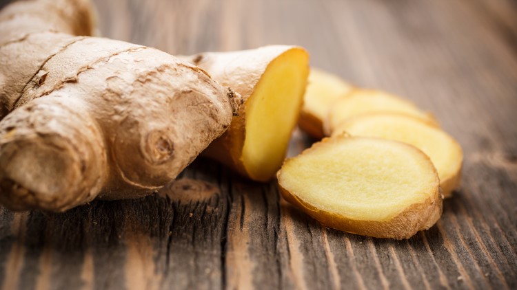 Pieces of ginger on wood surface