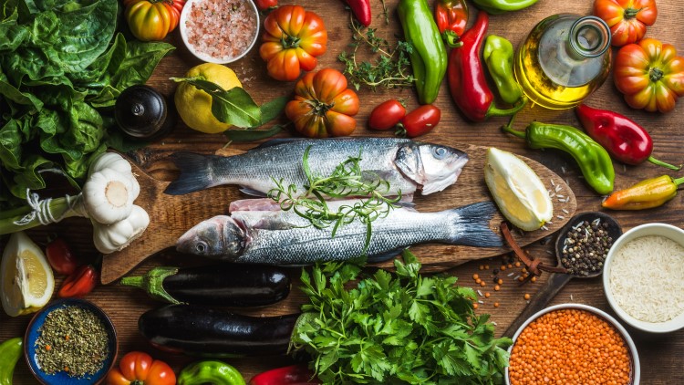 Raw seabass with vegetables scattered around